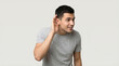 © Umme - Young man holding his ear in a thoughtful pose