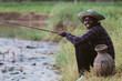 © arrowsmith2 - Happy African Man Fishing with Rod and Traditional Bamboo Basket