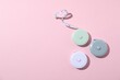 © New Africa - Measuring tapes on pink background, flat lay. Space for text