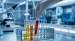 © Bano - Scientist handling test tubes with colored liquids in laboratory