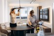 © Roman - Cleaning professionals tidying modern apartment for hospitality service