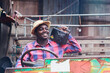 © arrowsmith2 - Happy African Man Listening to Portable Radio on Vintage Truck