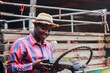 © arrowsmith2 - Cheerful African Man Adjusting Portable Radio on Old Wooden Truck