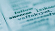 © AAUB - Macro photography of the word 'success' and its definition in a dictionary, concept for achievement, motivation, and career growth