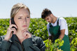 © auremar - female vintner talking on mobile phone in vineyard