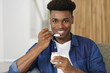 © auremar - smiling young man eating yogurt