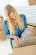 © auremar - a woman is unpacking boxes