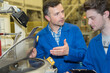 © auremar - apprentice learning to use a machine