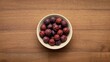 © VolumeThings - Dish of flavorful dried plums on timber surface