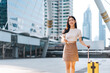 © dodotone - Beautiful confidence smile Freelance young adult asian woman walking with travel luggage for business trip