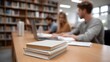© Thares2020 - Students collaborating and studying in a modern library surrounded by bookshelves and learning materials