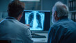© Anthichada - Doctor reviewing a chest X-ray with an elderly patient on a computer screen, discussing diagnosis and treatment in a clinical setting with focused, professional care