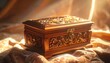 © hendrastudio - A beautifully crafted wooden jewelry box with intricate carvings and a polished finish, elegantly resting on patterned fabric under warm golden sunlight.