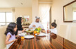 © oneinchpunch - Arab family wearing traditional emirati clothing bonding at home in Dubai