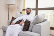 © oneinchpunch - Arabian man at home wearing traditional emirati clothing