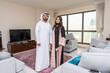 © oneinchpunch - Arab married couple wearing traditional emirati clothing at home - Middle eastern man and woman spending time together, domestic life in a traditional middle east family