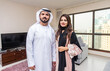 © oneinchpunch - Arab married couple wearing traditional emirati clothing at home - Middle eastern man and woman spending time together, domestic life in a traditional middle east family