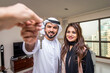 © oneinchpunch - Arab married couple wearing traditional emirati clothing at home - Middle eastern man and woman spending time together, domestic life in a traditional middle east family