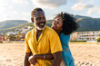 © oneinchpunch - Beautiful mature black couple of lovers dating at the seaside - African senior man and woman bonding outdoors at summertime