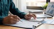 © Lisan - Professional accountant working with financial documents and calculator at desk
