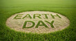 © Shah Zain - Earth Day text written in green grass on a patch of dry soil surrounded by lush lawn.