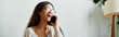 © LIGHTFIELD STUDIOS - Joyful young woman chatting on the phone in a bright, inviting living space