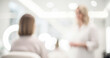 © al-sultan - A blurred image in a modern salon, showcasing a hairstylist talking to a client. The bright, airy environment emphasizes a relaxing atmosphere.