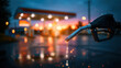 © Tiravad - Fuel nozzle dripping fuel at sunset with blurred gas station canopy and wet pavement reflecting warm lights