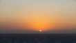 © Larry - Golden sunset over ocean horizon with vibrant orange sky and calm sea