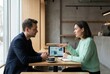 © Tima - Man and woman having business meeting in cafe. People sitting at table with tablet and coffee cup. Professional communication, collaboration, brainstorming and startup growth concept.