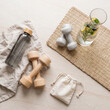 © paaz - Top Down Flat Lay of Minimalist Fitness Accessories and Wellness Ritual Items on Pale Stone Background