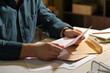 © New Africa - Man reading letter at wooden table indoors, closeup