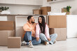 © Pixel-Shot - Happy young couple sitting in kitchen on moving day