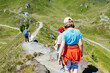 © Elena Medoks - Family hiking on mountain trail with dog in the austrian alps