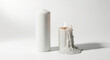 © Vid - Two white candles, one melted, on white background