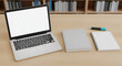 © Muhammad - Laptop mockup on desk with blank screen next to book and notebook in office setting providing a workspace for study and business needs
