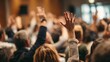 © ANDREI - People in an audience raising hands, asking a question, expressing opinion, or showing participation during a business conference