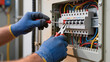 © Jakub - The electrician is working, The panel is open, He checks the wires, Tools are in use, It is electrical work, Maintenance is being done, The power is off, It is a professional job