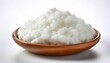 © James - a close up shot of a white fluffy and soft kefir grain the grain is isolated against a white white background allowing for a clear view of its texture and shape