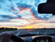 © keleny - View from the car window during a road trip at sunset with rain in the countryside