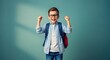 © graphiczone872 - Happy schoolboy with backpack celebrating success, excited young student with glasses and blue shirt on green background, joyful kid with raised fists
