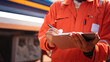 © Nattawit - An engineer is checking on chemical hazardous material checklist to verify the safety condition with chemical road tanker as background. Industrial waorking scene, close-up and selective focus.