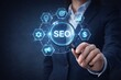 © Haseeb - SEO search engine optimization concept with magnifying glass highlighting digital marketing icons and analytics symbols