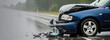 © Margharyta - Blue car involved in highway accident on rainy day. Damaged vehicle after collision with crushed bumper and broken glass on wet asphalt. Road safety, traffic insurance. Banner with copy space