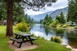 © Lubos Chlubny - Picnic table by river in rv park with mountains