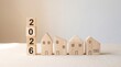 © ALAUDDIN - 2026 Real Estate Market wooden blocks with house icons for property investment and housing plan