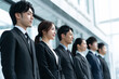 © PukupuKu - 整列する新入社員のビジネスチーム（日本の企業・採用イメージ）