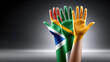 © syhin_stas - Two hands painted with the South African flag, one on each palm, symbolizing unity, reconciliation, diversity, and peace for the nation and Africa Day concepts. Africa Day