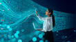 © Rendara Studio - Latin woman interacting with digital data wall using laptop
