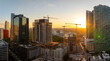 © bilanol - Real estate development in Miami urban area. Tower lifting cranes at high residential apartment building construction site at sunset